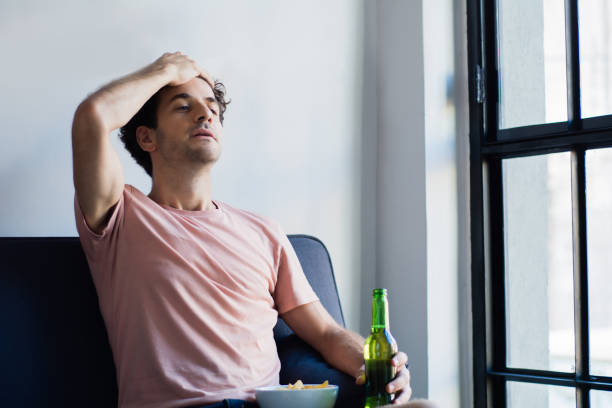 istock Young man watching tv on the couch. 1130325782