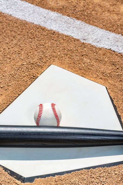 istock Looking down on a baseball and wooden bat on home plate 1130327547