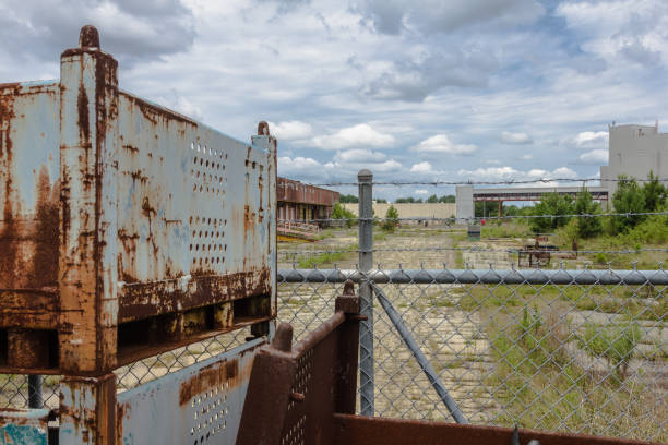 istock Rust covered industrial storage units outside an abandoned factory 1130327895