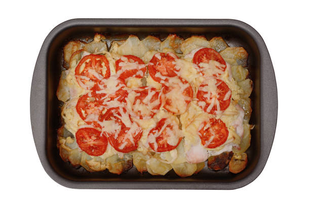 potato baked pudding with chicken meat, tomatoes and cheese isolated on a white background