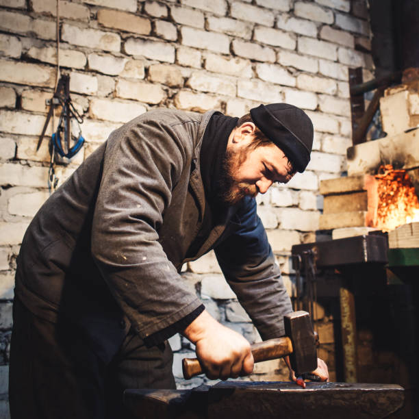 istock The blacksmith manually forging the red-hot metal on the anvil. 1130330661