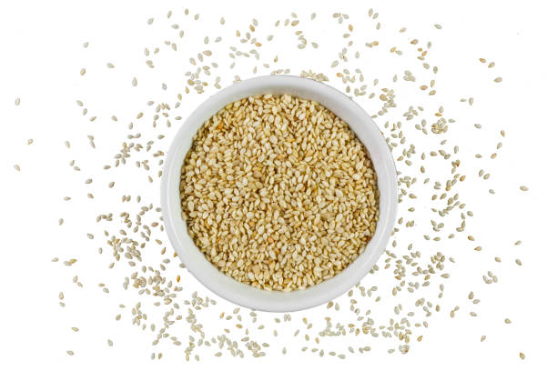 Sesame seeds in a bowl isolated on white background Sesame seeds in a bowl on white background shot directly from above sesame photos stock pictures, royalty-free photos & images