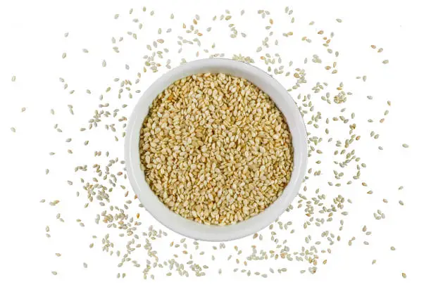 Photo of Sesame seeds in a bowl isolated on white background