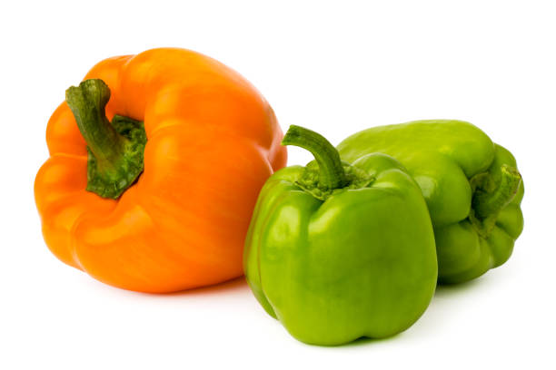istock One orange pepper and two green on a white isolated. 1130335074