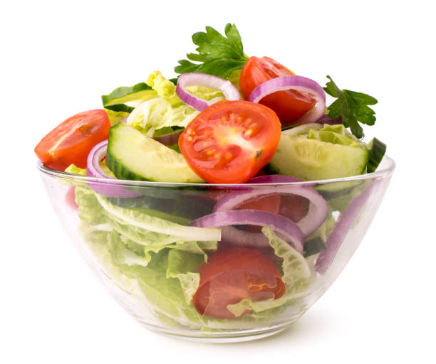istock Fresh vegetable salad in glass plate on a white, close up. 1130335186