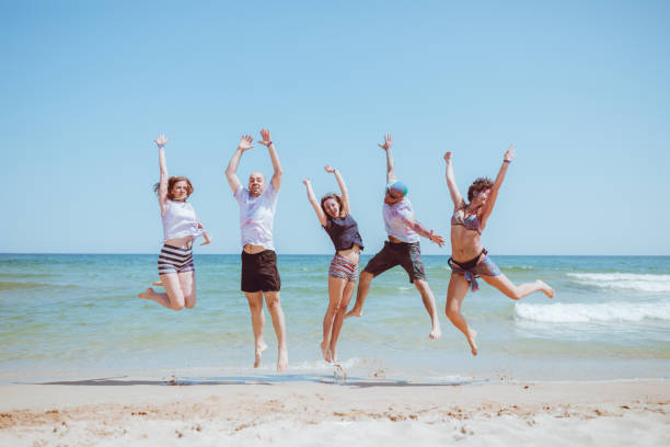 istock Jump of joy at the beach 1130335215