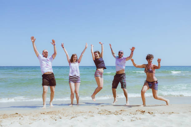 istock Jump of joy at the beach 1130335354