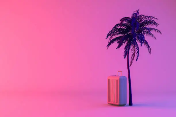 Photo of Tropical palm tree and suitcase on neon color background, minimal summer and travel concept