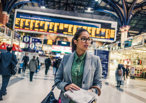 istock woman waiting at the train station 1130336425