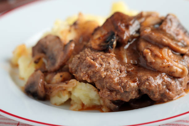 Salisbury steak with mashed potato Salisbury steak with mashed potato under mushroom gravy salisbury steak stock pictures, royalty-free photos & images