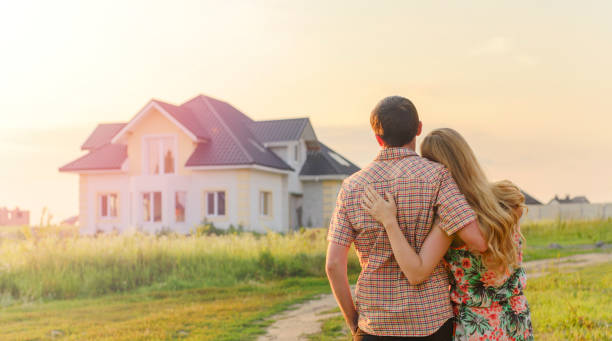 istock Young Couple Standing Outside Dream Home 1130338451