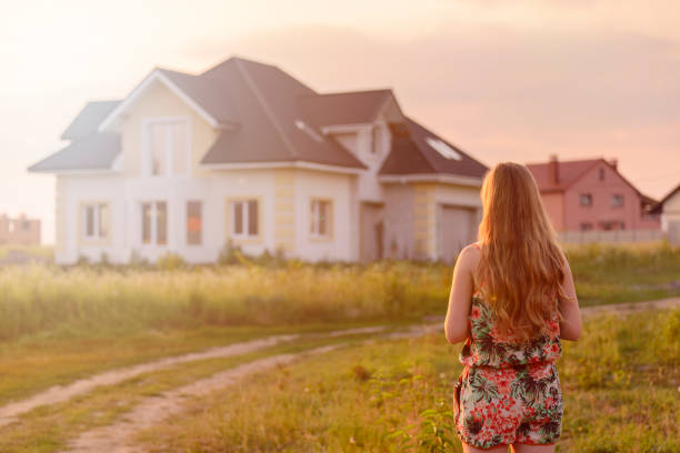 istock Girl looking on the house in sunset 1130338546