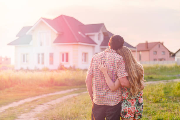 istock Young Couple Standing Outside Dream Home 1130338566