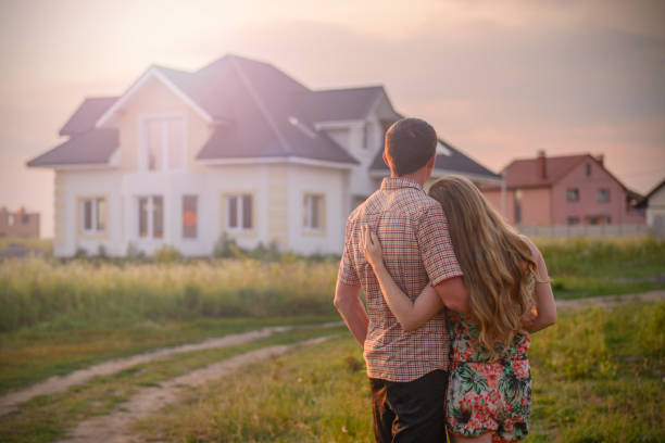 istock loving couple looking at their home 1130338568