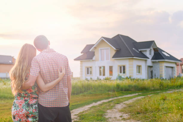 istock young couple near his house 1130338627