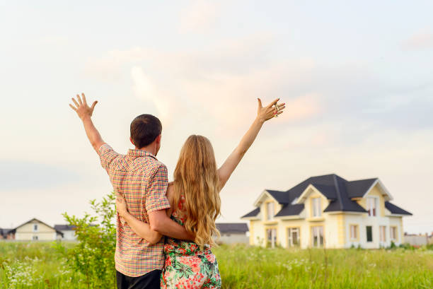 istock young couple near his house 1130339276