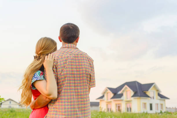 istock loving couple looking at their home 1130339361