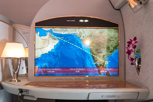 Dubai, United Arab Emirates - January 07, 2019: Interior of a First Class Suite on an Emirates Airlines Boeing 777-300 airplane, showing the passenger's individual entertainment screen. The Airline only has 8 First Class Seats on the B777-300. Image taken on mobile device. Close-up, no people.
