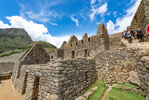 Cusco, Peru - Oct 16, 2018: Machu Picchu aerial view. Tourists are walking through the old abandoned city.