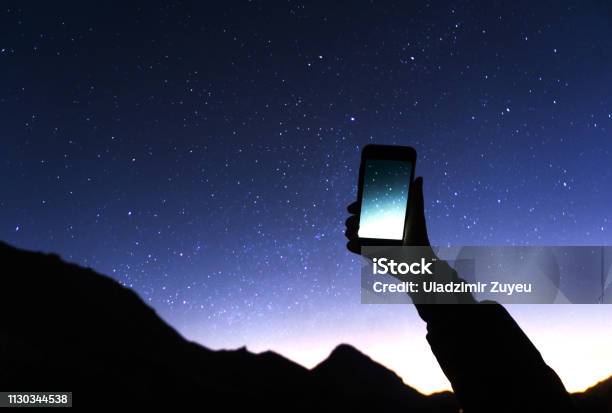A Hand Is Holding Smartphone With Starry Sky Photo A Man Is Taking A Photo Starry Sky At Night Milky Way And Galaxy On Dark Sky Wifi Mobile Internet Concept Stock Photo - Download Image Now
