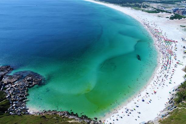 Long Beach, Arraial do Cabo, Rio de Janeiro, Brazil. Vacation travel. Travel destination. Great colors and contrast. Aerial view of Arraial do Cabo, Rio de Janeiro, Brazil: paradise beach with blue water. Fantastic landscape. Great beach view. Vacation travel. Travel destination. Brazillian caribbean. arraial do cabo stock pictures, royalty-free photos & images