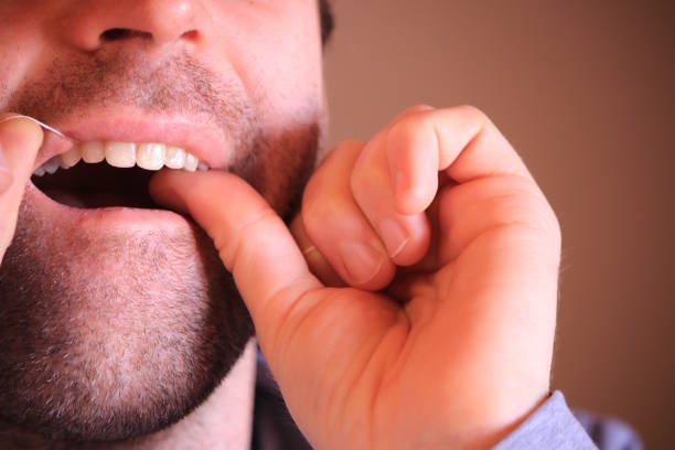 istock Mature man cleaning teeth with floss 1130347094