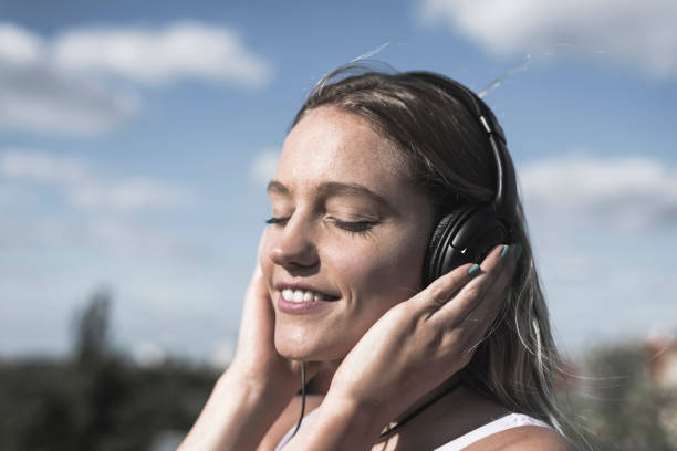 istock young woman with headphones 1130347549