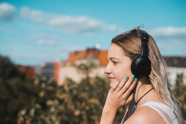 istock young woman with headphones 1130348349