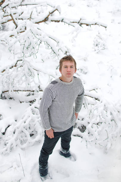 istock young man on a walk in the winter forest 1130348682