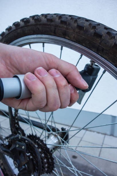 istock Air pump on bicycle tire by hand 1130349486