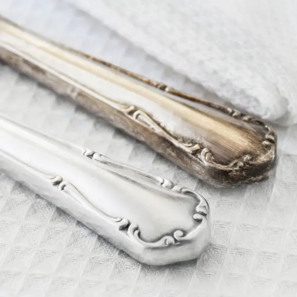Cleaning tarnished silverware comparison close up