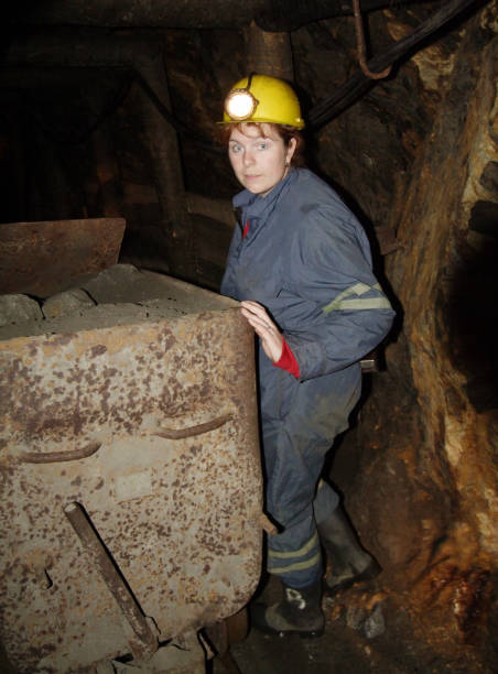 istock Miner woman in a underground mine. Working people on workplace. 1130352789