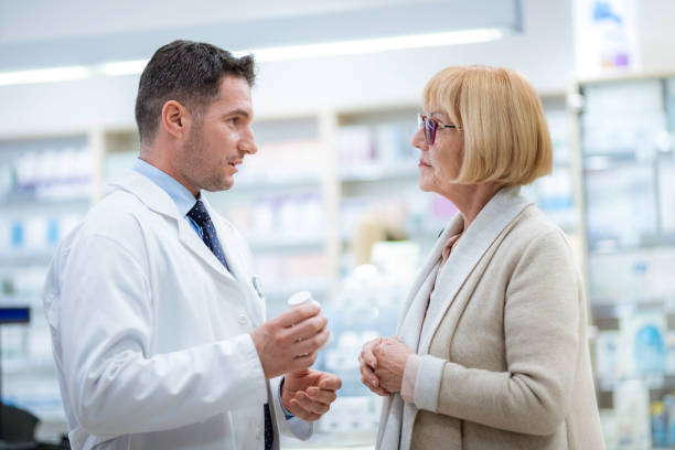 istock Senior woman consulting with pharmacist 1130354126