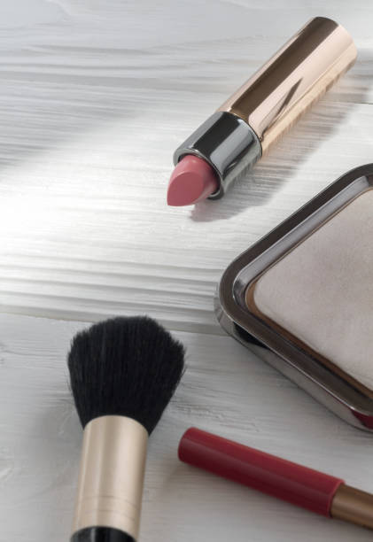 istock Pink Lipstick and make up accessories on wooden white background 1130354546