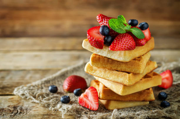 istock Waffeles with berries and mint leaf on a wood background 1130355428