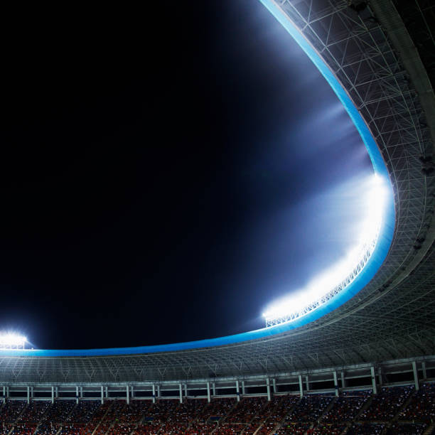 istock Spotlights and floodlights at a stadium at night 1130356907