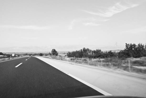istock Road markings on an empty motorway with directions 1130356968