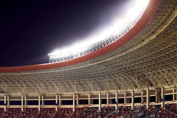 istock Spotlights and floodlights at a stadium at night 1130356979
