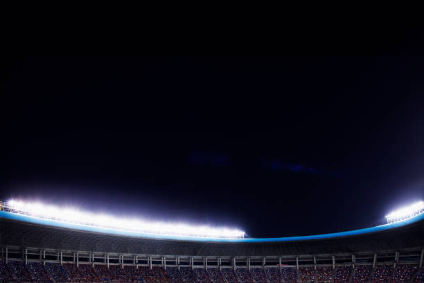 istock Spotlights and floodlights at a stadium at night 1130357732