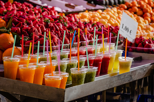 A variety of colorful, fruity drinks on ice at market in Valencia