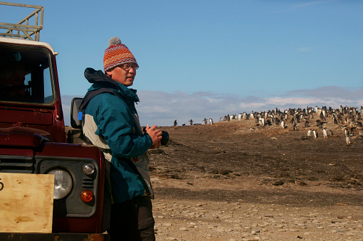 Men view King Penguins at St Andrews Bay South Georgia