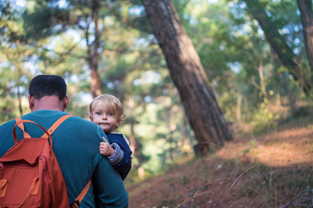 istock Father and daughter walking in forest 1130360765