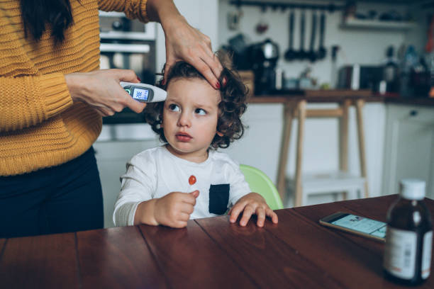istock Measuring little boy's temperature 1130362538