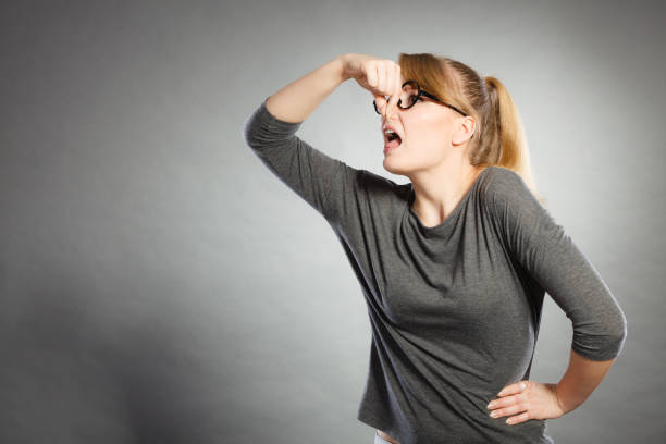 istock Nerdy girl holding nose. 1130362578