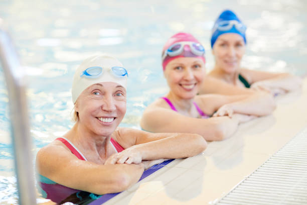 istock Three Mature Women Posing in Pool 1130365631