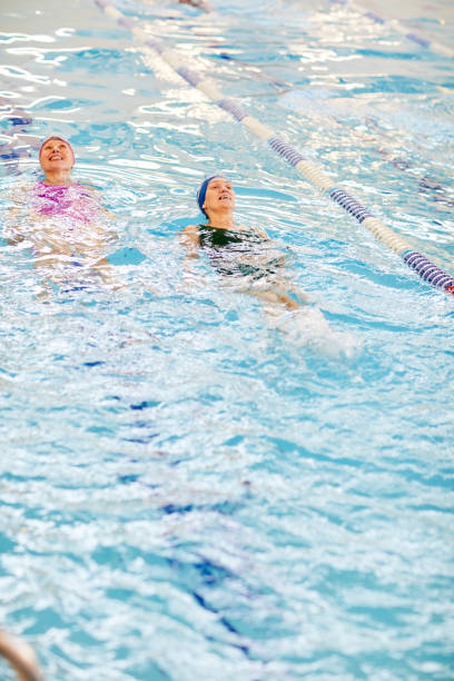 istock Two Women Swimming in Pool 1130365633