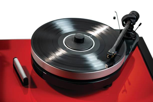 istock Close up view of audio record player with black vinyl disk on red surface isolated. Beautiful backgrounds. 1130365851