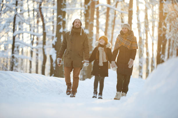 istock Happy Family Enjoying Walk in Winter Forest 1130366591