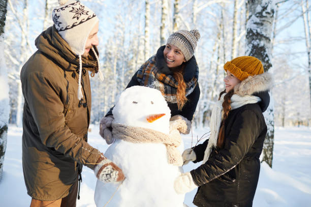 istock Family Building Snowman 1130366616