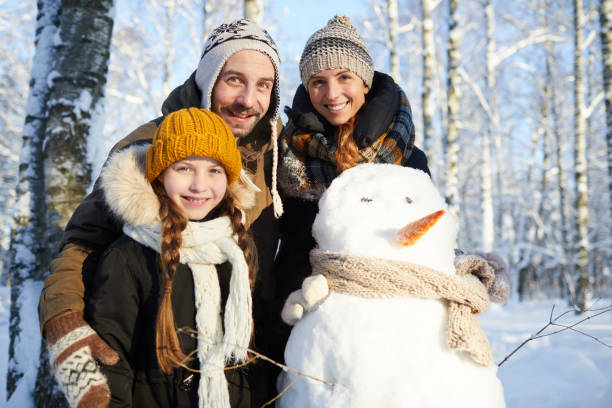 Family Posing with Snowman